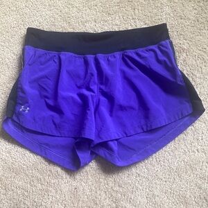 Purple under armour running shorts with liner and pocket on back.